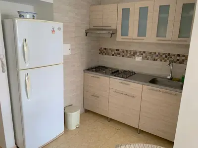a kitchen with a white refrigerator and a sink at Apartamento con hermosa vista y cerca de playas in Cartagena de Indias