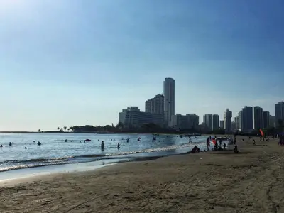 a beach with people in the water and buildings at Apartamento con hermosa vista y cerca de playas in Cartagena de Indias