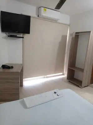 a room with a bed and a tv on a wall at Hotel Damys in Sincelejo