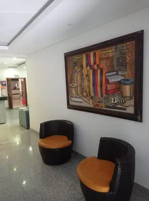a room with two chairs and a painting on the wall at Hotel Damys in Sincelejo