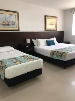 two beds in a hotel room with two beds at San Martin Cartagena in Cartagena de Indias