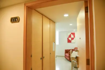 a hallway with a door leading to a room at Hotel American Golf in Barranquilla