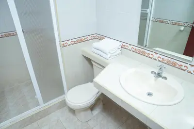 a white bathroom with a toilet and a sink at Ayenda 1313 Barahona 72 in Barranquilla