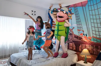a group of children jumping on a bed at Hotel Las Americas Casa de Playa in Cartagena de Indias