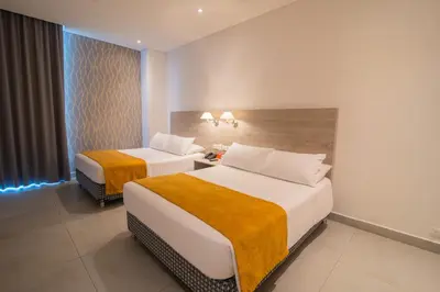 a hotel room with two beds and a window at Hotel Zi One Luxury in Cartagena de Indias