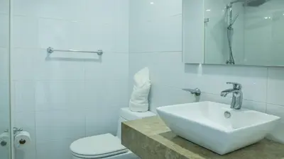a white bathroom with a sink and a toilet at OCEAN VIEW SPACIOUS PENTHOUSES WITH BIG TERRACES AND OVER 318 Square Meters in Cartagena de Indias