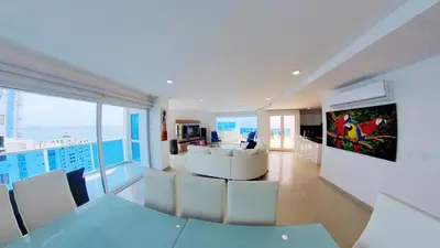 a living room with a couch and a table and chairs at OCEAN VIEW SPACIOUS PENTHOUSES WITH BIG TERRACES AND OVER 318 Square Meters in Cartagena de Indias