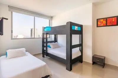 two bunk beds in a room with a window at 41st Fl Beach Condo in Bocagrande in Cartagena de Indias