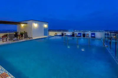 a swimming pool on top of a building at night at GHL Hotel Barranquilla in Barranquilla