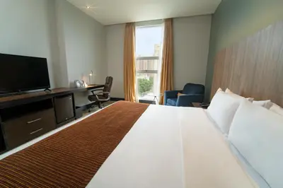 a hotel room with a large bed and a television at GHL Hotel Barranquilla in Barranquilla