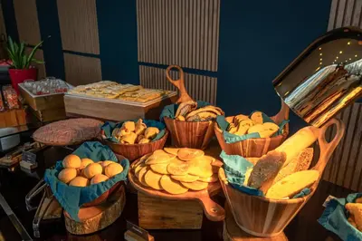 a table with baskets of different types of bread at GHL Hotel Barranquilla in Barranquilla