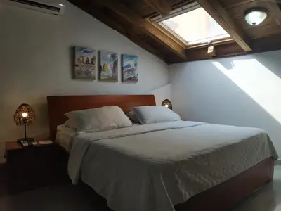 a bedroom with a large bed with a window at Casa India Catalina in Cartagena de Indias