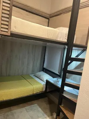 a room with two bunk beds and a ladder at Hostel la Antigua Capsula in Cartagena de Indias