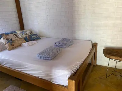 a bed in a room with two pillows on it at El palmar azul in San Bernardo del Viento