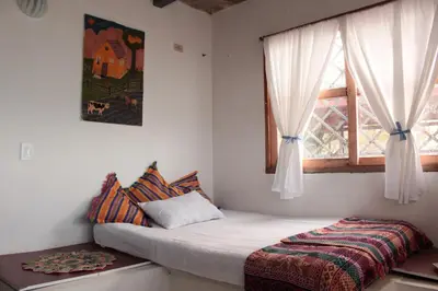 a small bedroom with a bed and a window at Frente al Mar in Santa Veronica
