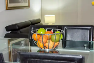 a bowl of fruit sitting on a glass table at Mirador del Laguito 1201 in Cartagena de Indias