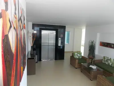 a lobby with couches and a hallway with a door at Hotel Altamar Cartagena in Cartagena de Indias