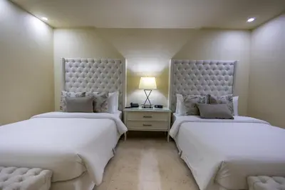 two beds sitting next to each other in a bedroom at Hotel Casa Canabal by Faranda Boutique in Cartagena de Indias