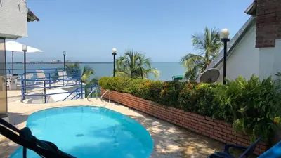 a swimming pool with a view of the ocean at Casa Miramar in Santa Marta