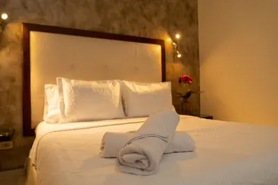 a bedroom with a bed with towels on it at Hotel Virrey Cartagena in Cartagena de Indias