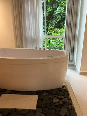 a bath tub in a bathroom with a window at Hotel Playa Club in Cartagena de Indias
