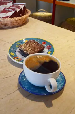 a cup of coffee and a piece of cake on a table at Hotel Playa Club in Cartagena de Indias