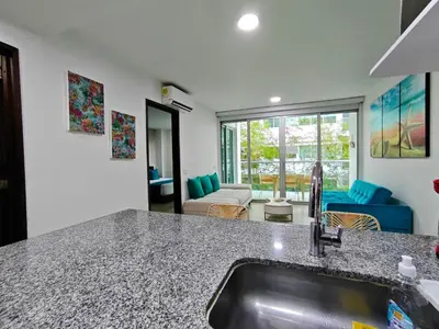 a kitchen with a sink and a living room at Edificio Morros Vitri in Cartagena de Indias