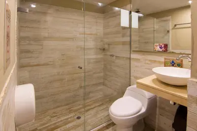a bathroom with a toilet and a sink at The Clock Hostel & Suites in Cartagena de Indias