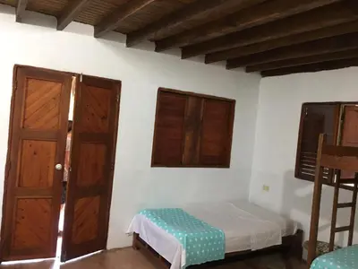 a bedroom with a bed and a wooden door at Luna azul in San Bernardo del Viento