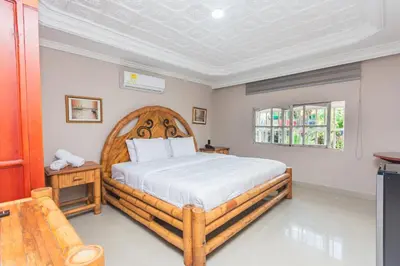 a bedroom with a wooden bed in a room at Hotel Baluarte Cartagena Boutique in Cartagena de Indias