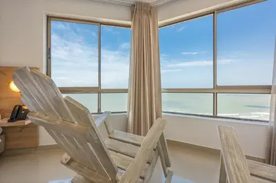 a wooden rocking chair in front of a window at Hotel Regatta Cartagena in Cartagena de Indias