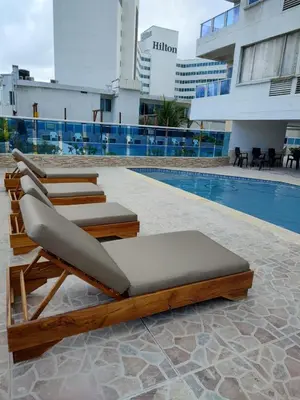 a group of lounge chairs next to a pool at El Nuevo Conquistador in Cartagena de Indias
