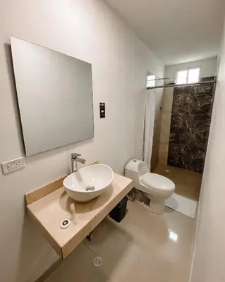 a bathroom with a sink and a toilet and a mirror at Hotel G Cartagena in Cartagena de Indias