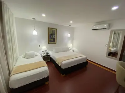 a hotel room with two beds in a room at Hotel Casa Colonial in Barranquilla