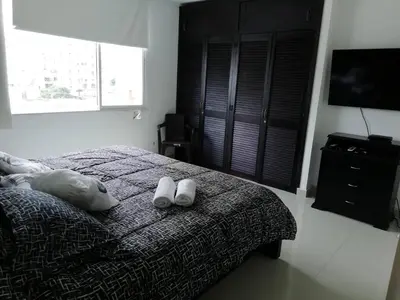 a bedroom with a bed with two white shoes on it at Hermosa vista Mar in Cartagena de Indias