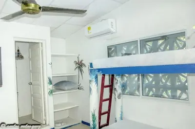 a room with a bunk bed with a ladder at Cabañas Los Juanchos Coveñas in Coveñas