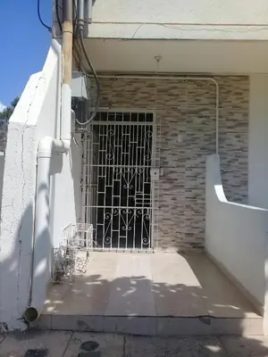 a gate on the side of a brick building at Hotel Paseo Bolivar in Cartagena de Indias