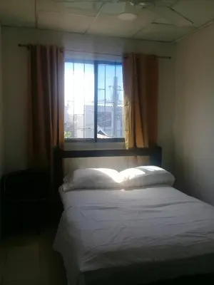 a bedroom with a bed and a window with a book at Hotel Paseo Bolivar in Cartagena de Indias