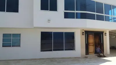 a person sitting on the outside of a building at Blue Gold Beach in Juan de Acosta