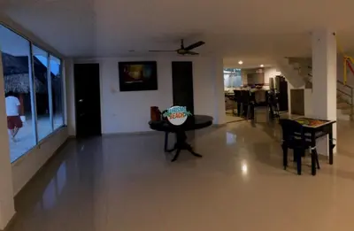 a living room with a table and a dining room at Blue Gold Beach in Juan de Acosta