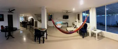 a living room with a hammock in a house at Blue Gold Beach in Juan de Acosta