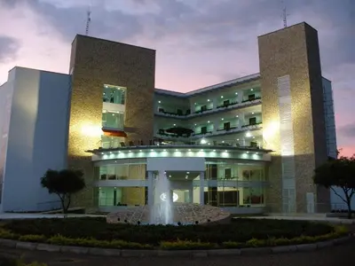 a building with a fountain in front of it at Hotel Isla Verde in Tubará