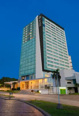 a large building with a sign on the side of it at Estelar Alto Prado in Barranquilla