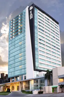 a tall building with a sign on the side of it at Estelar Alto Prado in Barranquilla