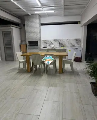a dining room with a wooden table and chairs at Sun Beach in Puerto Colombia