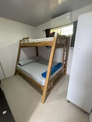 two bunk beds in a room with a refrigerator at Deusades Apartamentos in Cartagena de Indias