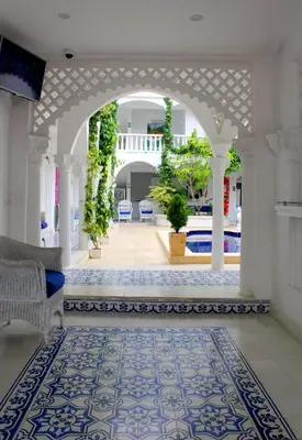 a living room with an archway and a pool at Hotel Casa Mara By Akel Hotels in Cartagena de Indias