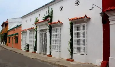 a white building with white doors and plants on it at Hotel Casa Mara By Akel Hotels in Cartagena de Indias