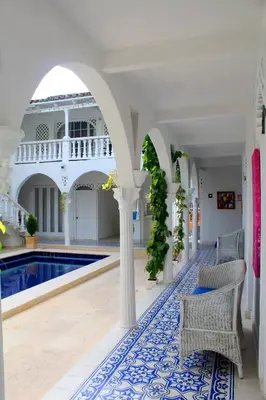 a house with a swimming pool and an archway at Hotel Casa Mara By Akel Hotels in Cartagena de Indias