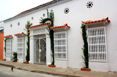 a white building with ivy growing on it at Hotel Casa Mara By Akel Hotels in Cartagena de Indias